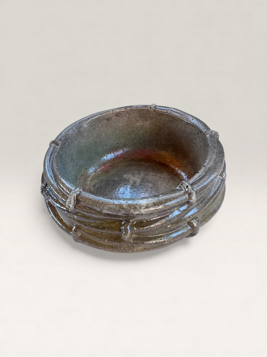 Hand-poured brownish red concrete catch-all bowl with nest texture