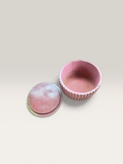 Minimalist concrete jar with lid in warm yellow color palette