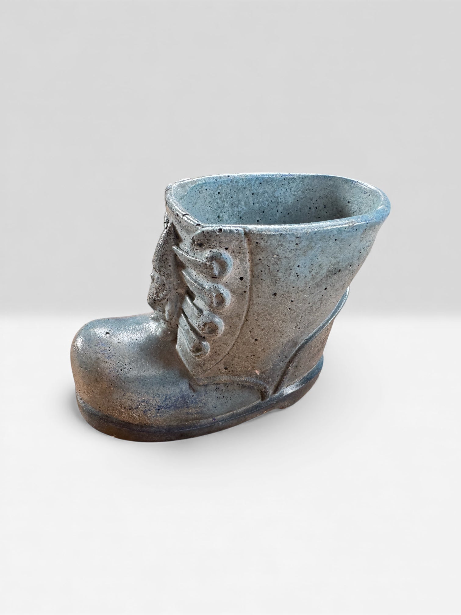 Modern whimsical concrete decor boot used as plant holder