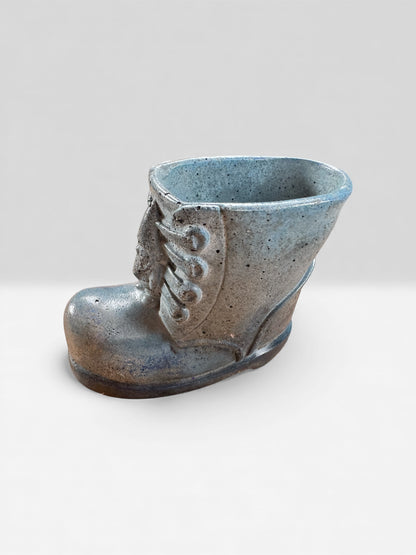 Modern whimsical concrete decor boot used as plant holder