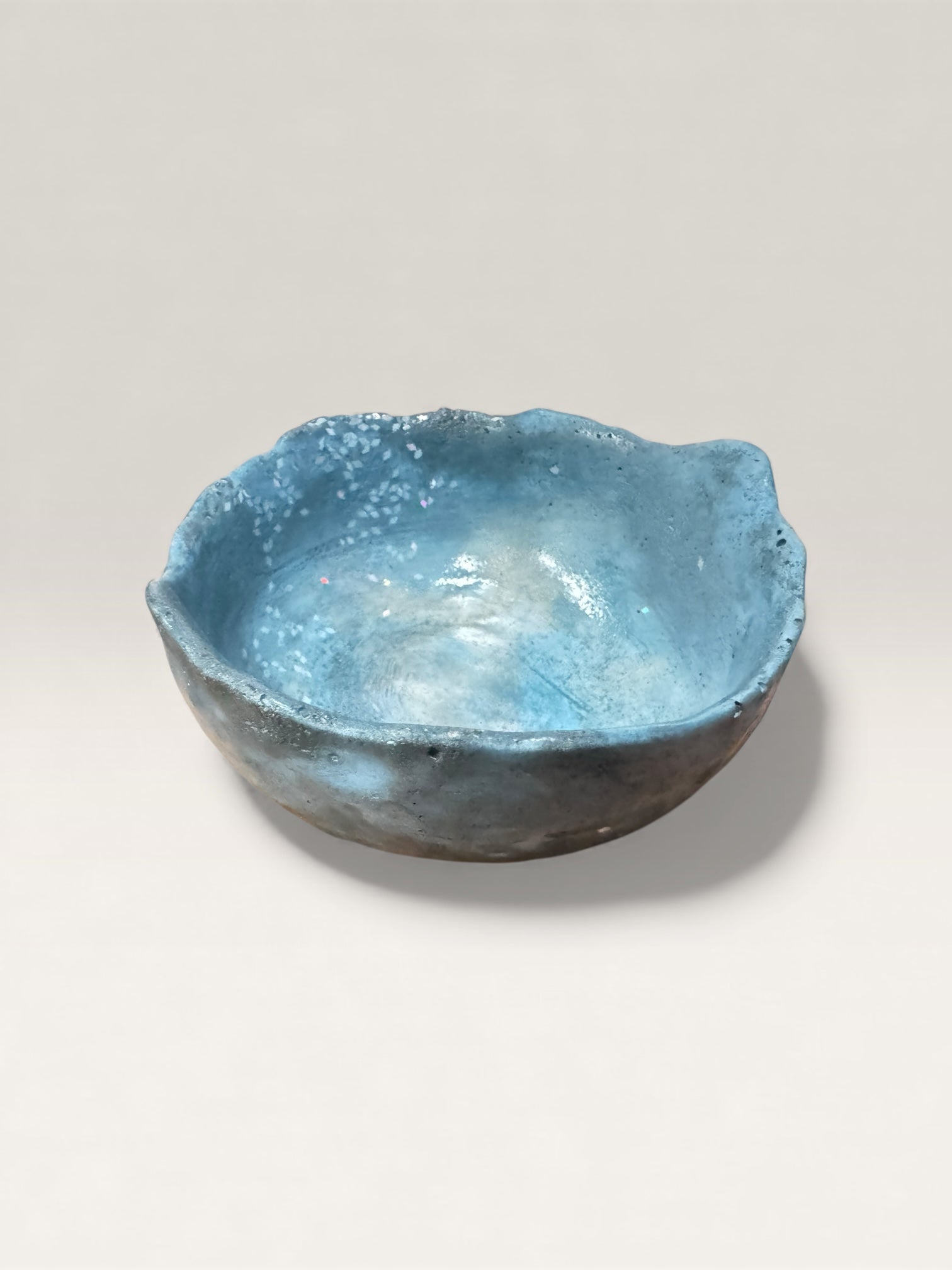 Soft blue concrete bowl with smooth stone-like surface
