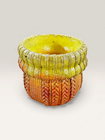 Yellow and terracotta concrete planter with knit-textured design