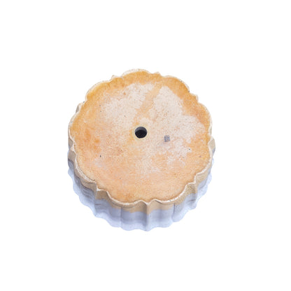 Bottom view of the Studio Line Lotus Planter showing the drainage hole and maker mark